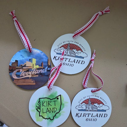 Four round tags with Kirtland, Ohio branding on a beige surface.