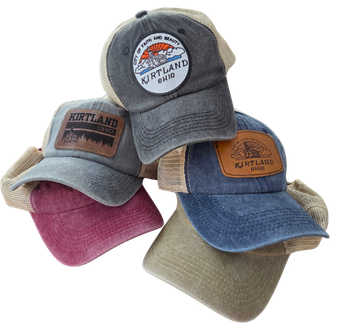 Four baseball caps in different colors with visible branding on a white background